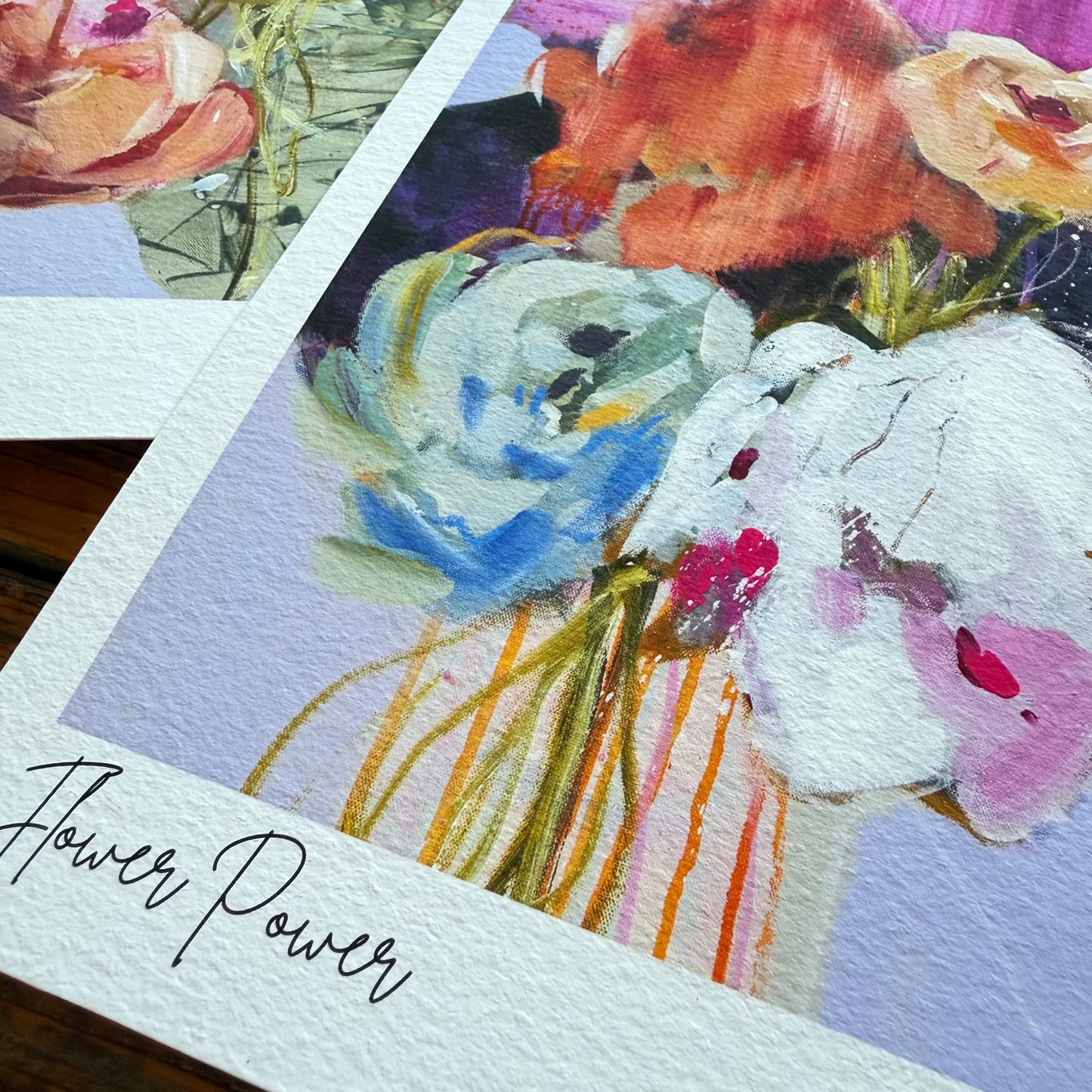 Floral art cards with 'Flower Power' text on a wooden surface