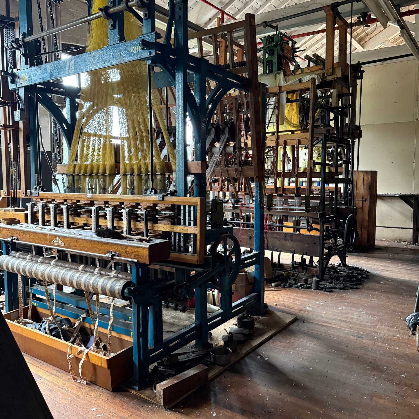 Complex mechanical structure inside a building with wooden beams and floors.