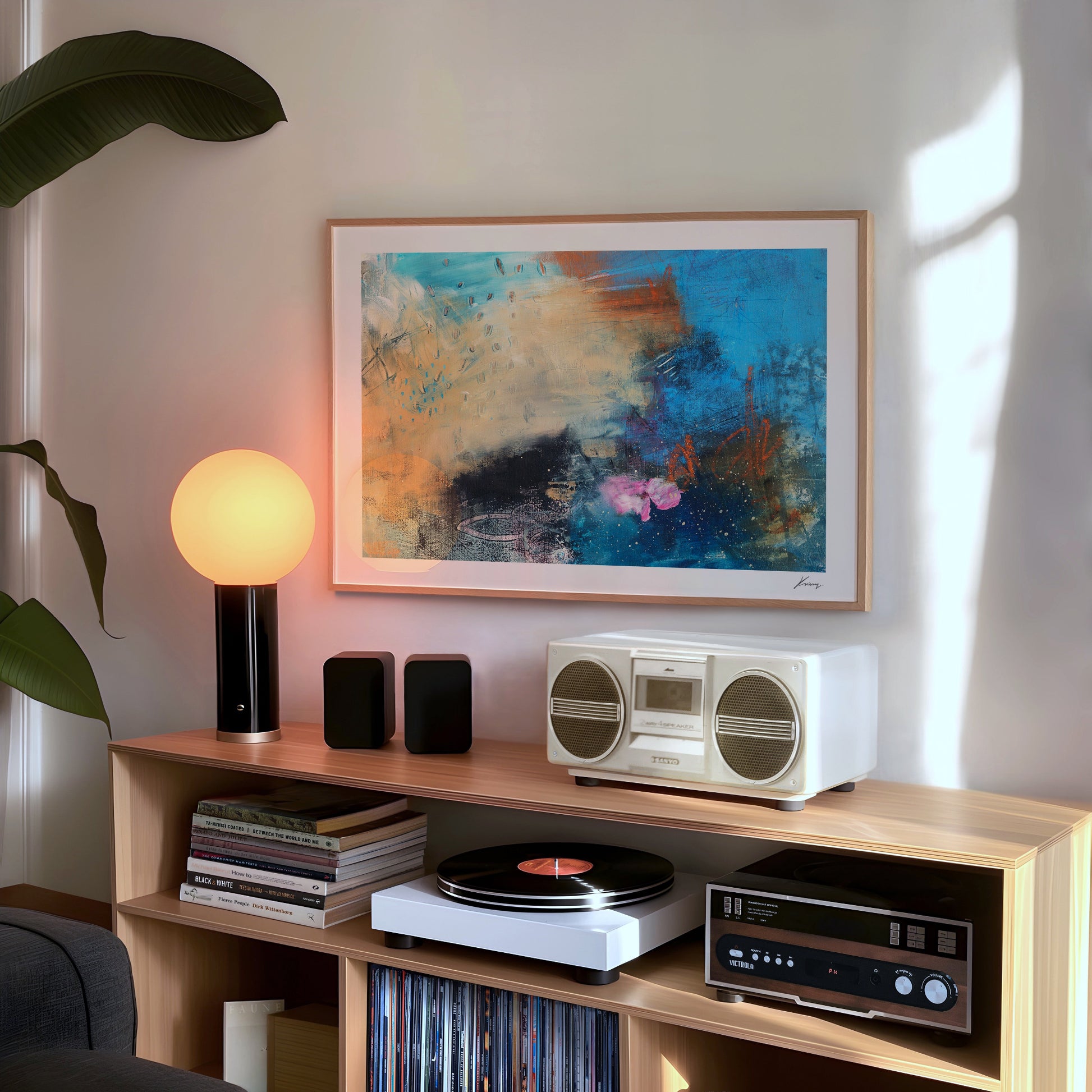 Wooden entertainment console with vintage radio, speakers, and records in a room with abstract art and lamp.