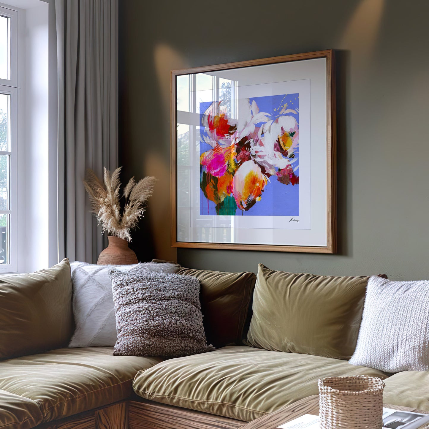 Living room with a floral painting on the wall above a beige sofa.