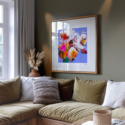 Living room with a floral painting on the wall above a beige sofa.