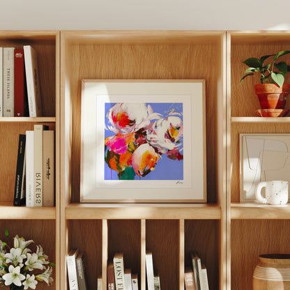 Framed floral artwork on a wooden bookshelf with books and decor items.