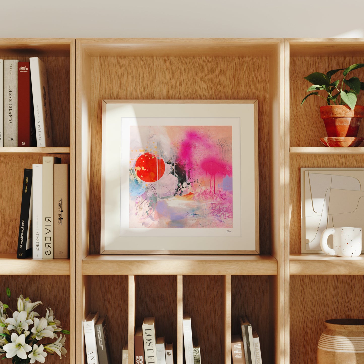 Wooden bookshelf with books, a colorful abstract painting, and decorative items.