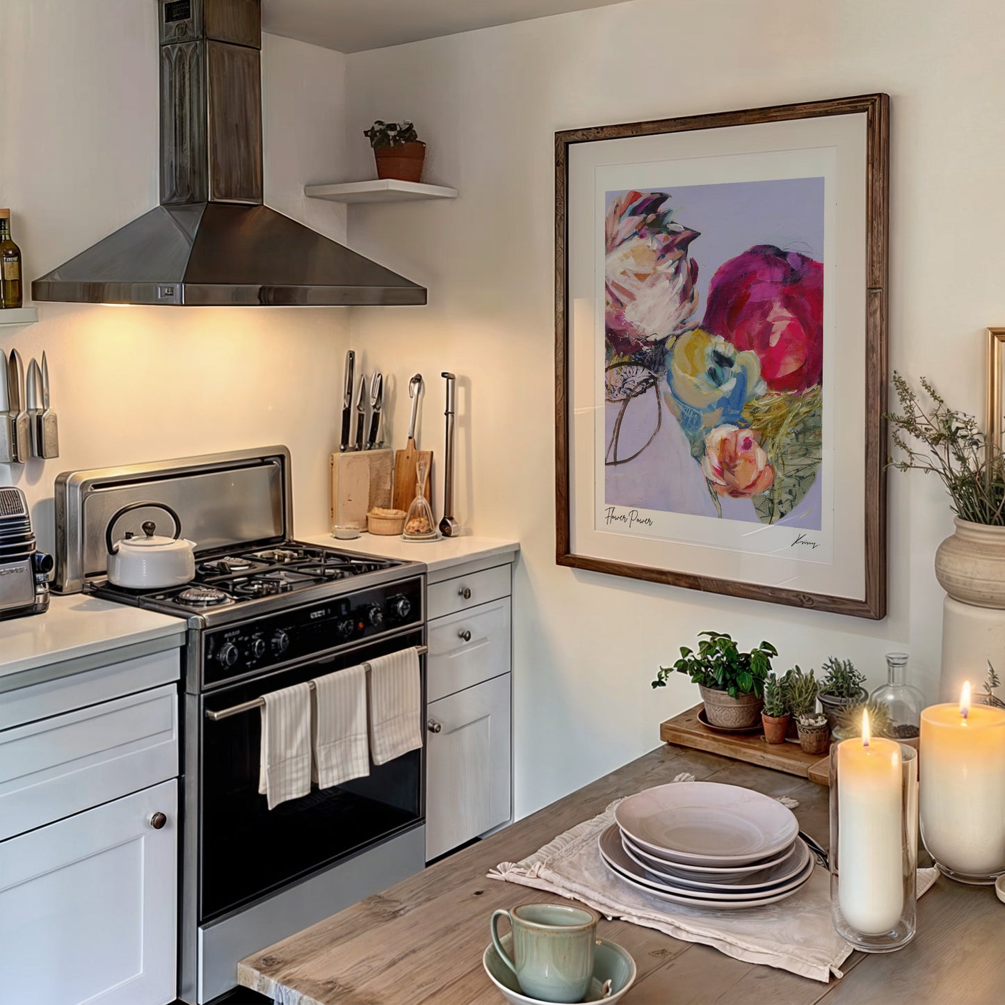 Kitchen with stove, utensils, and decorative elements including a floral painting and candles.