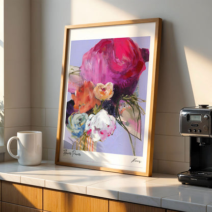 Colorful abstract art print on a kitchen counter with a coffee machine and mug.