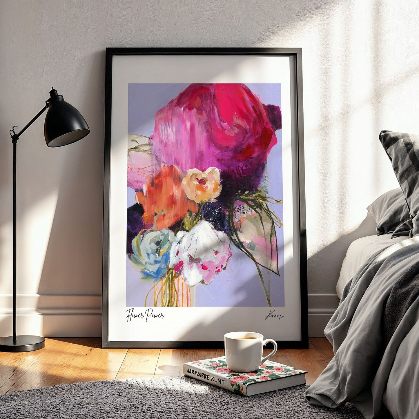 Framed abstract floral artwork in a bedroom setting with a lamp and bed.