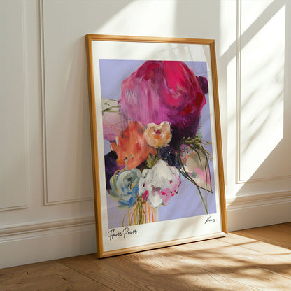 Framed abstract art print on a wall with sunlight casting shadows