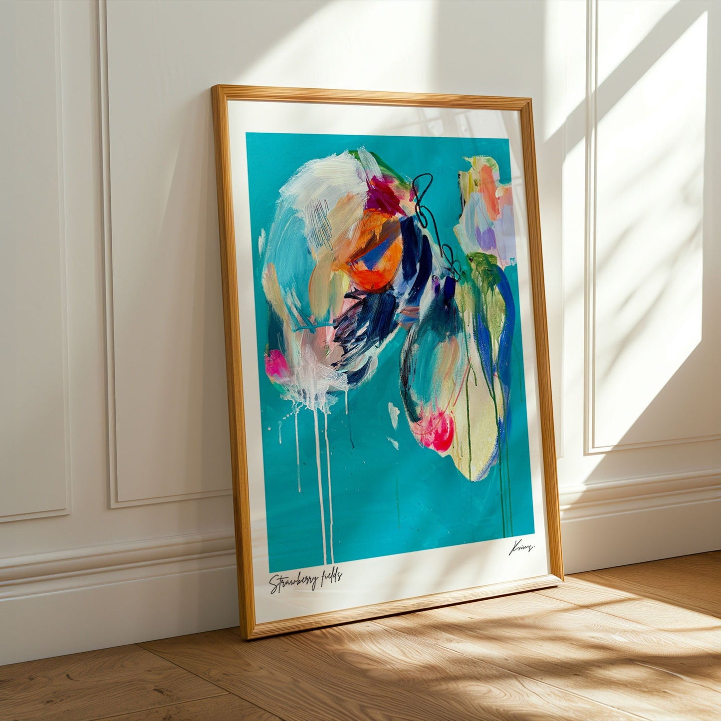 Framed abstract artwork on a wall with sunlight casting shadows