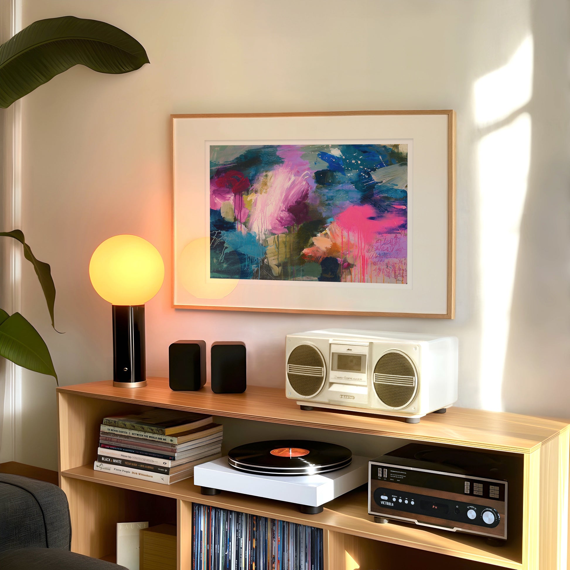 Wooden shelf with stereo equipment, books, and a colorful abstract painting on a wall.
