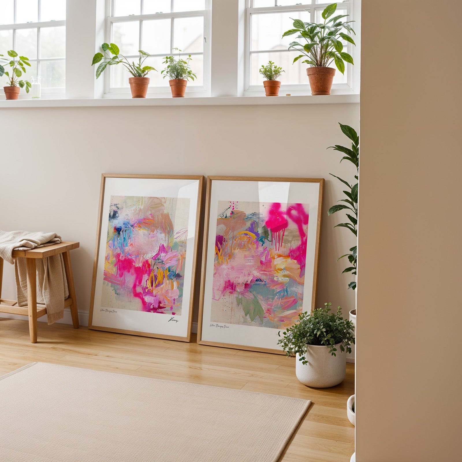 Set of two framed abstract art prints leaning against a wall