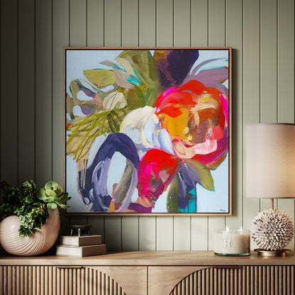 Colorful abstract painting on a wall above a wooden console table with decorative items.