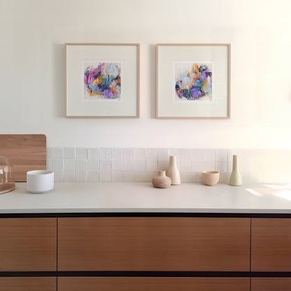 Modern kitchen with wooden cabinets, white countertop, and colorful abstract art on the wall.