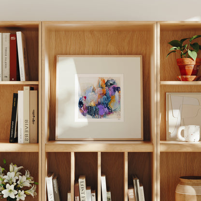Wooden bookshelf with books, a framed abstract painting, and decorative items.
